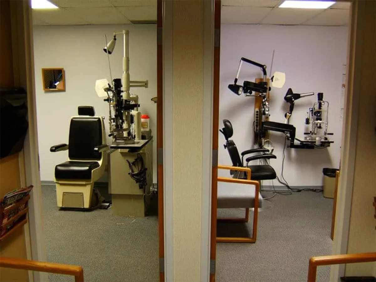 Two adjacent exam rooms, left room is under unfiltered fluorescent light, right room has a NaturaLux filter installed
