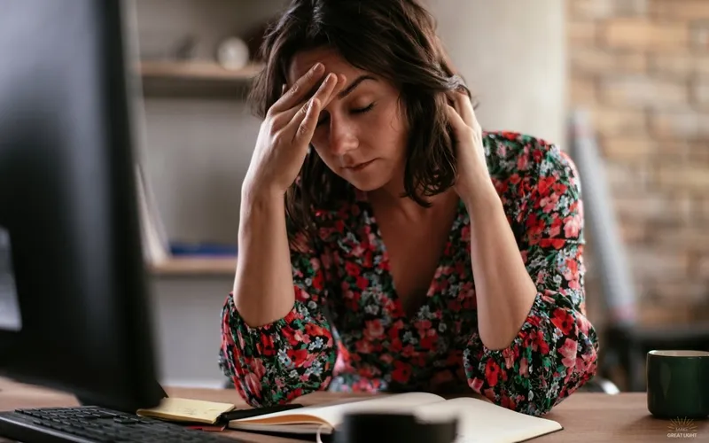 A person working comfortably under softened overhead lighting with NaturaLux filters
